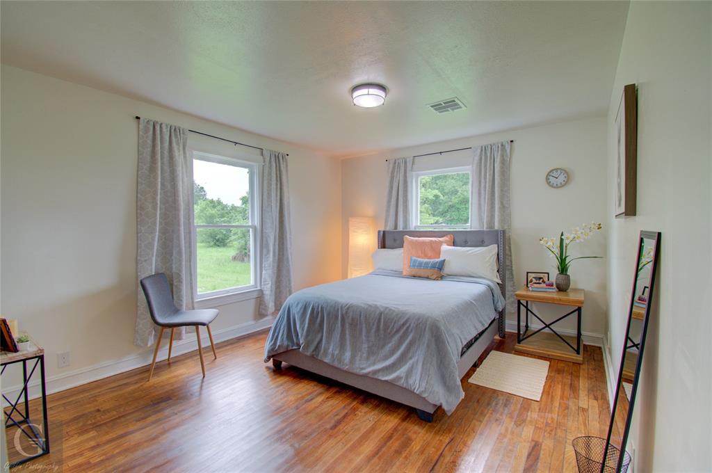 116 Loop Street Bossier City, LA 71111 - Photo 11 of 21 a bedroom with a bed windows and wooden floor