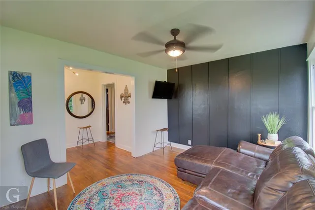 a bedroom with a bed a chandelier with a dresser and a chandelier