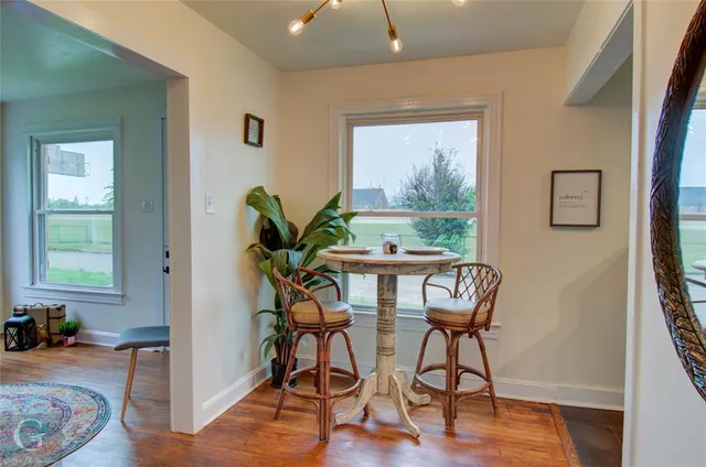 a dining room with furniture and wooden floor