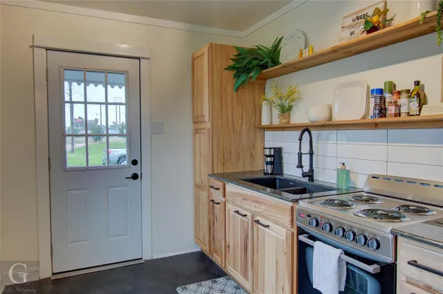 a kitchen with a stove and a sink
