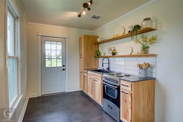 a kitchen with a stove and cabinets