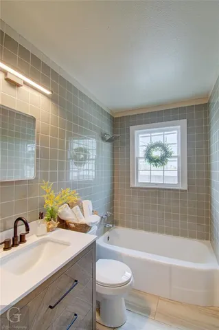 a bathroom with a sink mirror toilet and bathtub
