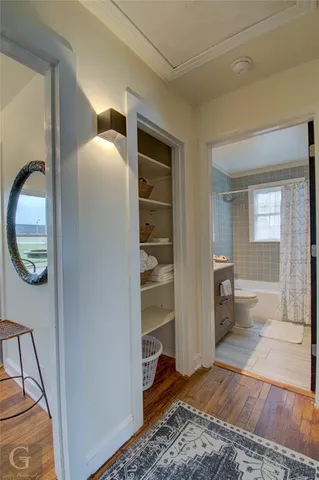 a view of a hallway to a livingroom with furniture
