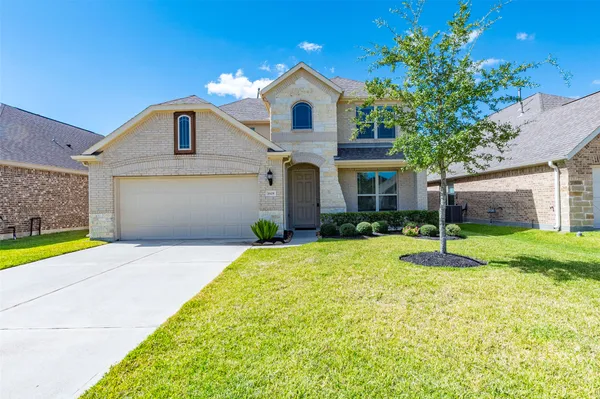 a front view of a house with a yard and garage