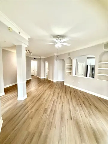 a view of empty room with wooden floor