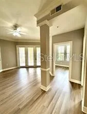 a view of a living room with hardwood floor and a window