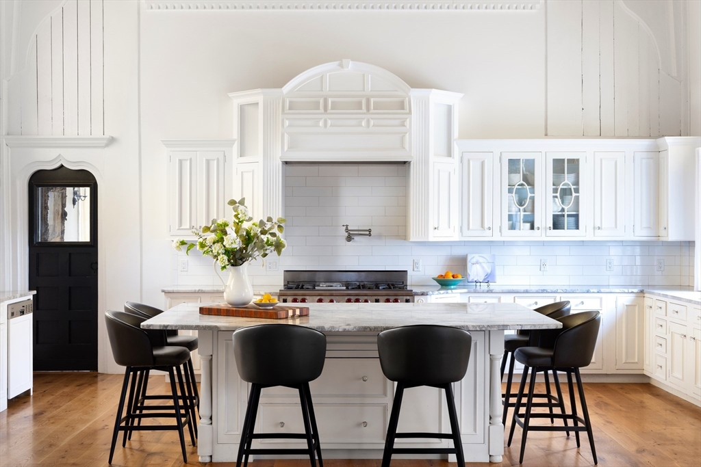 279 Main Street Groton, MA 01450 - Photo 4 of 9 a kitchen with a table chairs stove and cabinets