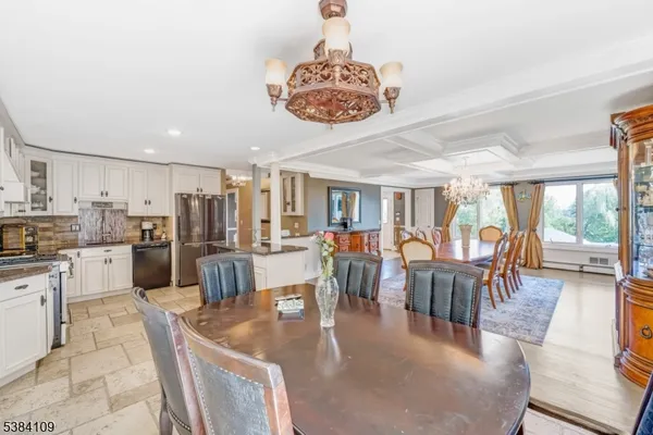a living room with lots of furniture and a large window