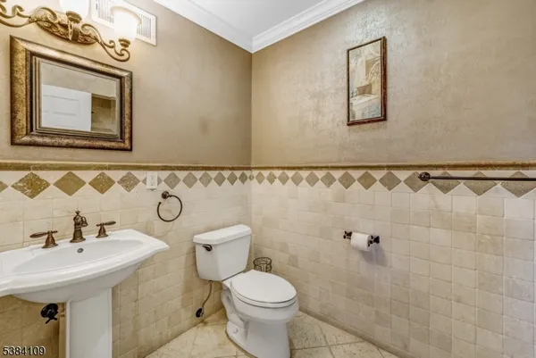 a bathroom with a sink mirror and toilet