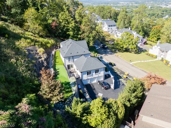 an aerial view of a house with a yard and lake view