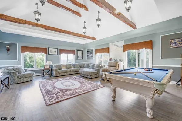 a living room with furniture a rug and a large window