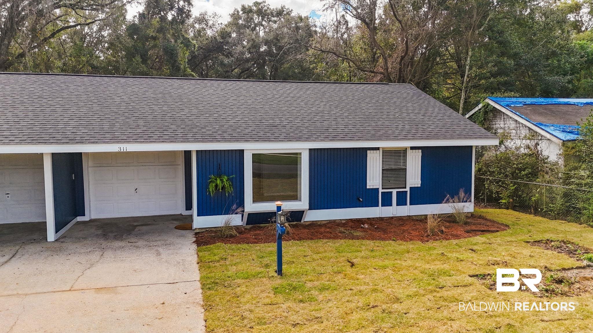 309 West Roosevelt Avenue Foley, AL 36535 - Photo 24 of 60 View of front of property with a front yard and a garage