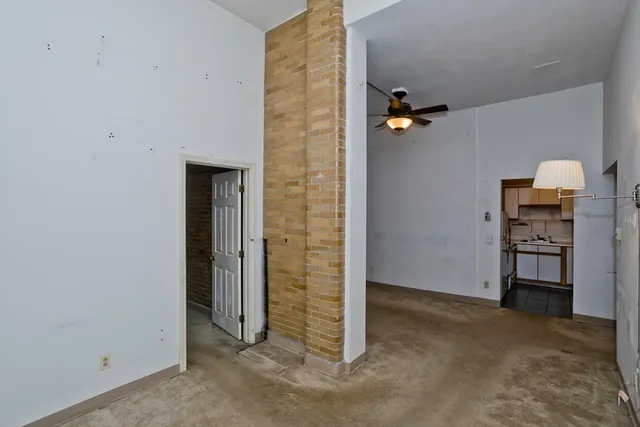 an empty room with closet and natural light