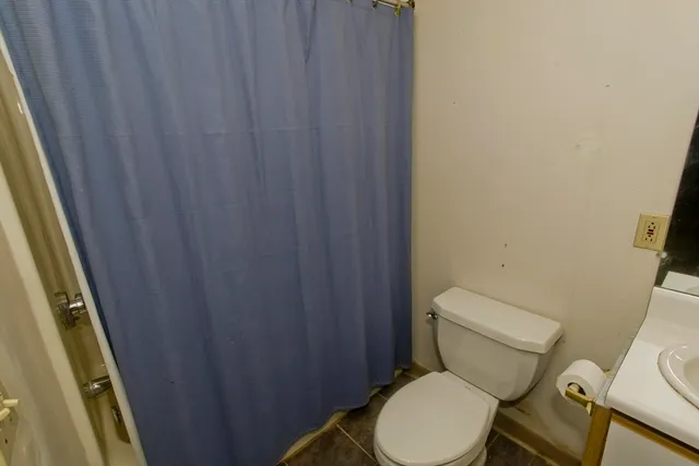a white toilet sitting next to a small sink