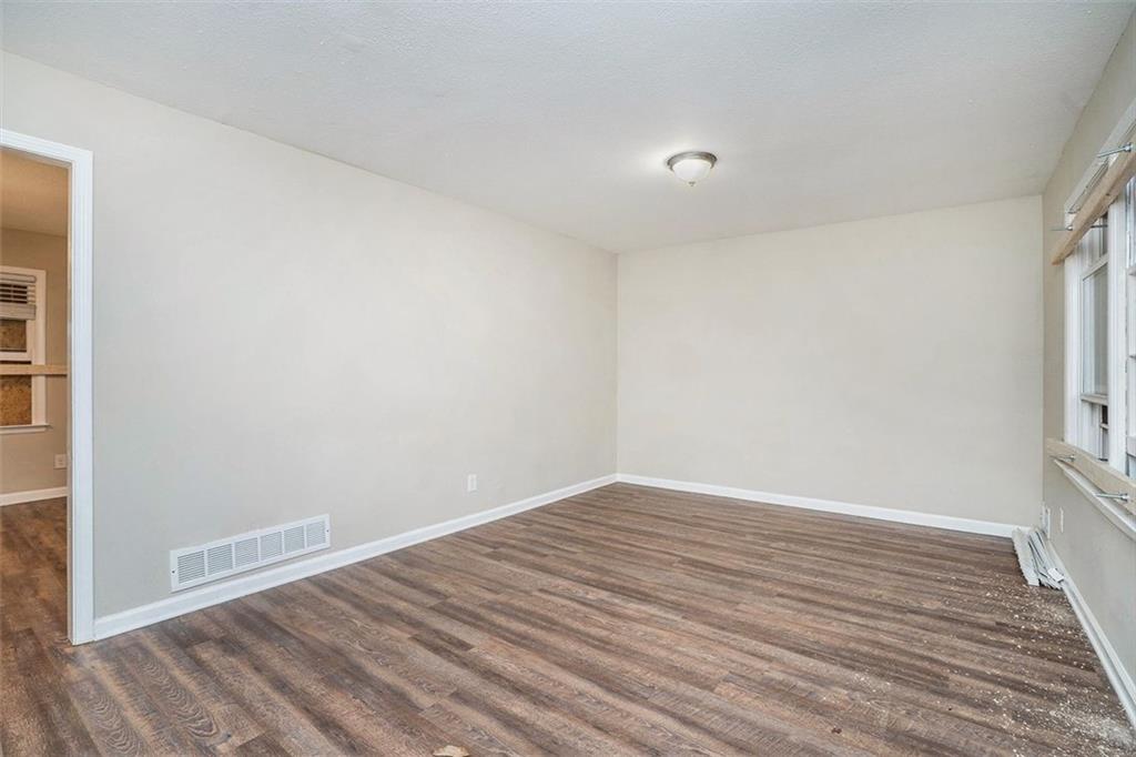 1714 Camperdown Circle Decatur, GA 30035 - Photo 11 of 15 a view of an empty room with wooden floor and a window