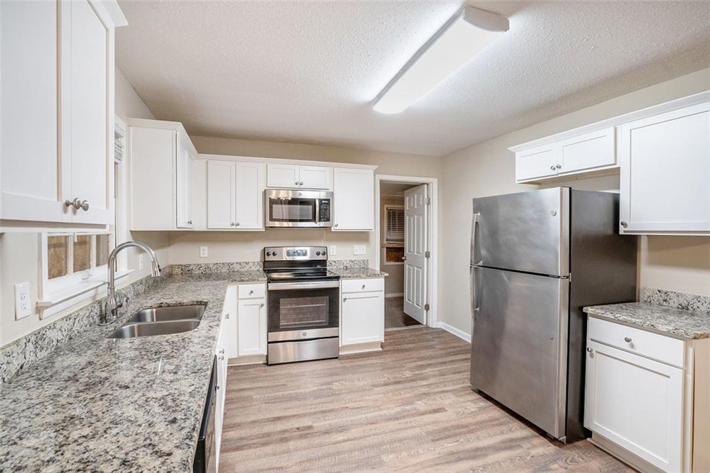 1714 Camperdown Circle Decatur, GA 30035 - Photo 12 of 15 a kitchen with stainless steel appliances granite countertop a refrigerator stove microwave and sink