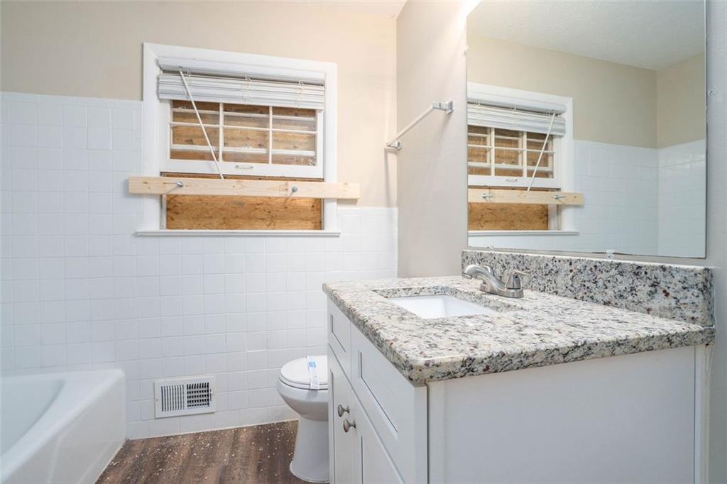 1714 Camperdown Circle Decatur, GA 30035 - Photo 4 of 15 a bathroom with a granite countertop sink and a mirror