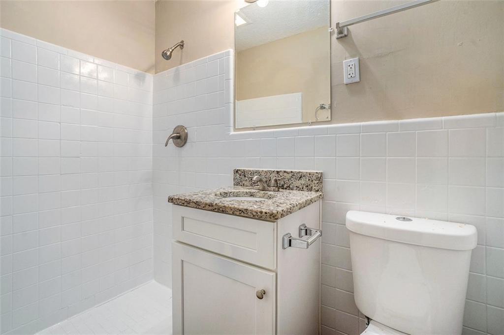1714 Camperdown Circle Decatur, GA 30035 - Photo 7 of 15 a bathroom with a granite countertop sink a toilet and a mirror