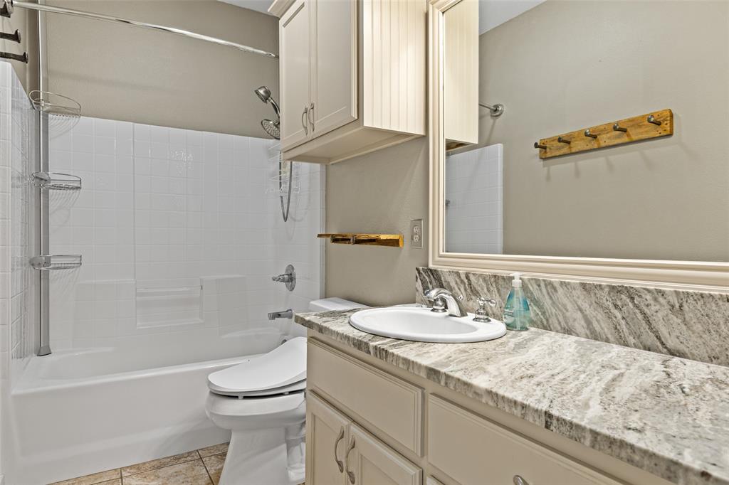 1321 North Fm 1970 Timpson, TX 75975 - Photo 13 of 29 a bathroom with a granite countertop sink a toilet and shower