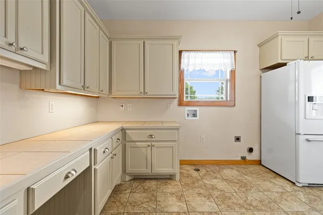 an aerial view of residential houses with outdoor space and lake view