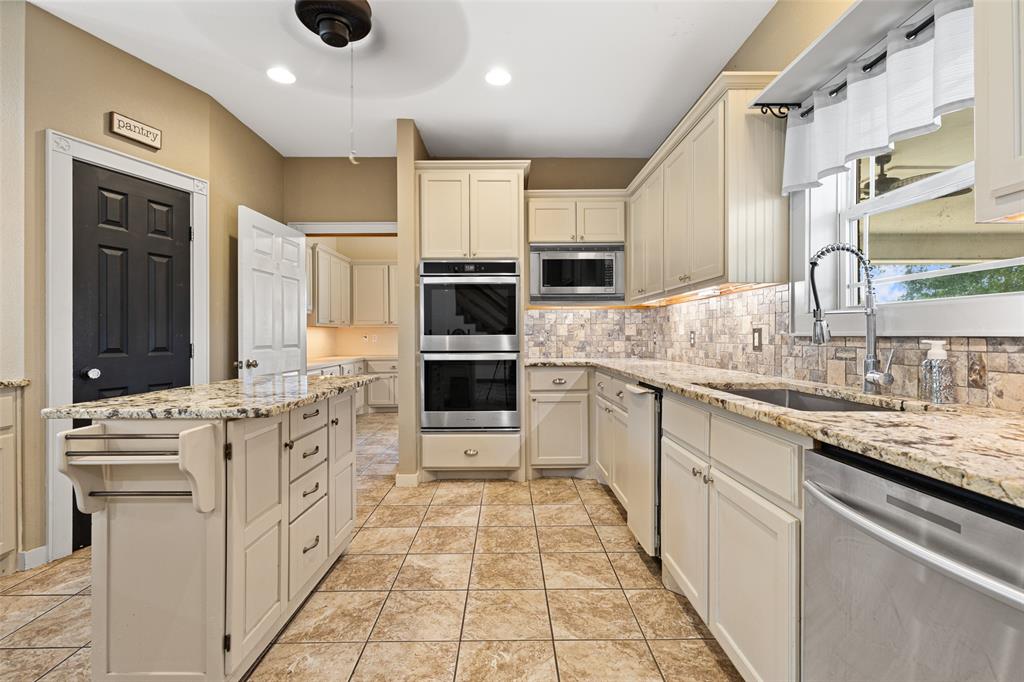 1321 North Fm 1970 Timpson, TX 75975 - Photo 4 of 29 a kitchen with stainless steel appliances kitchen island granite countertop a sink and cabinets