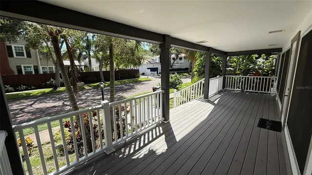 a room with wooden floor and windows