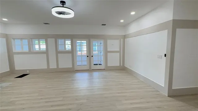 a kitchen with stainless steel appliances granite countertop a refrigerator stove and white cabinets