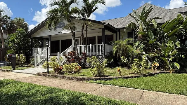 a front view of house with a garden