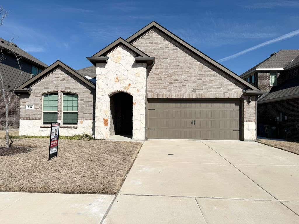 804 Marigold Street Princeton, TX 75407 - Photo 1 of 19 French country style house with a garage, stone siding, driveway, and brick siding