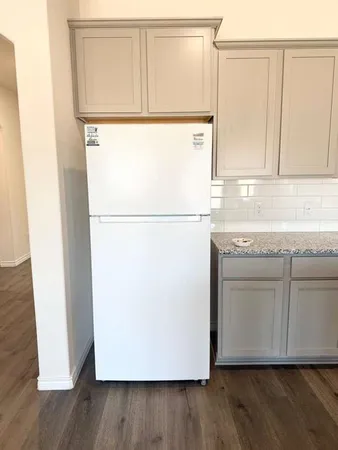 a white refrigerator freezer sitting inside of a kitchen