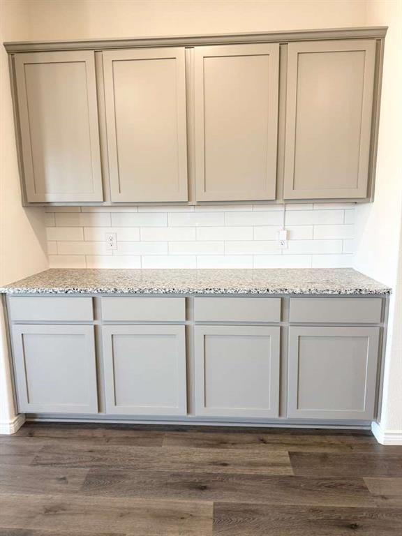 804 Marigold Street Princeton, TX 75407 - Photo 13 of 19 Detailed view of wood finished floors and decorative backsplash