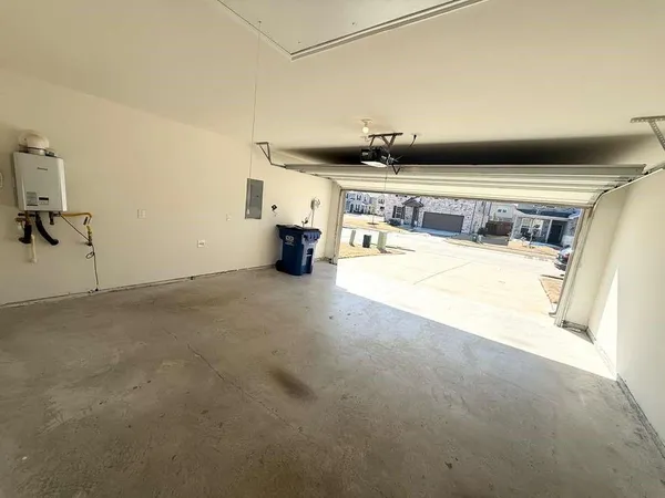 a view of a kitchen with a sink and a refrigerator