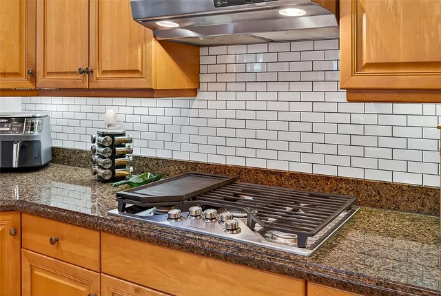 a stove top oven sitting inside of a kitchen
