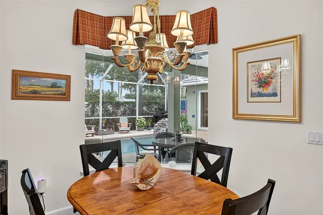 a dining room with wooden floor a glass table and chairs