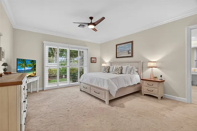 a spacious bedroom with a bed and a large window