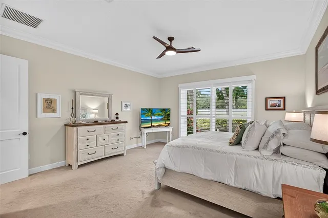 a bedroom with a bed dresser and a window