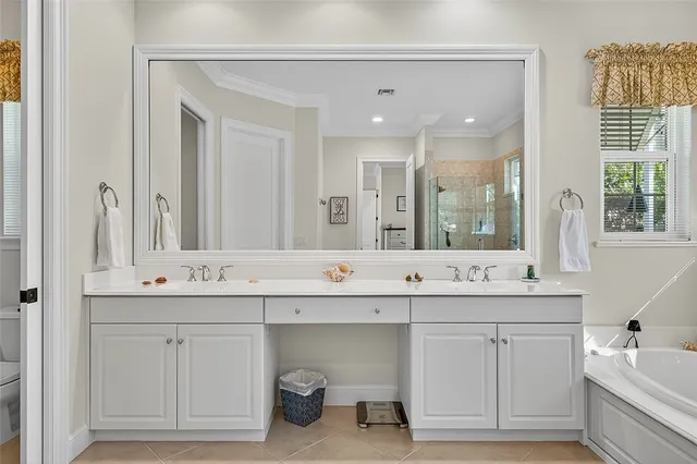 a bathroom with a sink double vanity mirror and bathtub