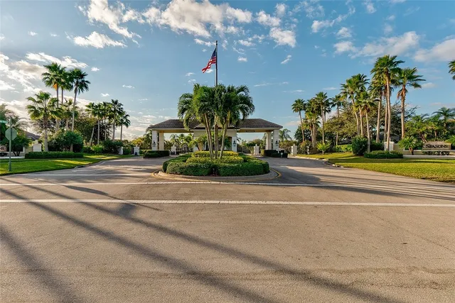 a view of a fountain in a yard with palm trees