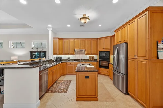 a large kitchen with stainless steel appliances lots of counter space and a refrigerator