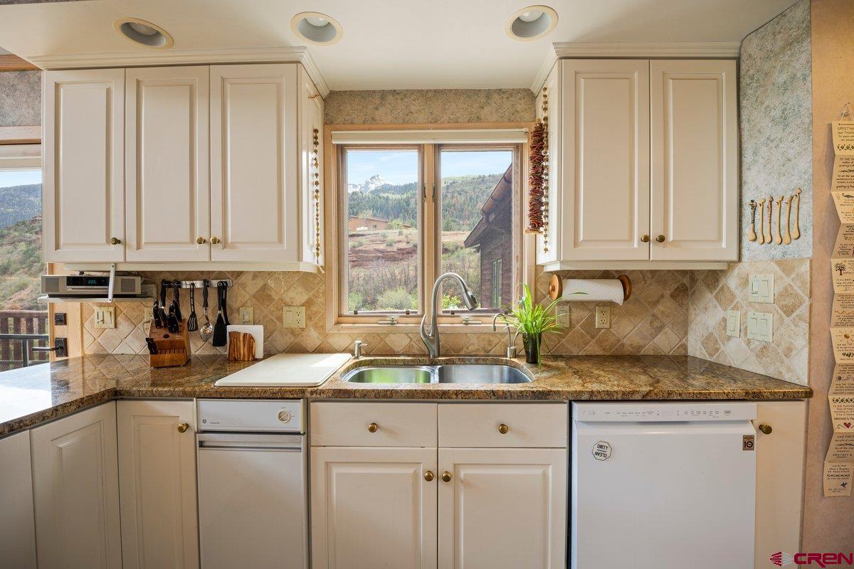 2490 County Road 17 Ridgway, CO 81432 - Photo 21 of 26 a kitchen with sink cabinets and window