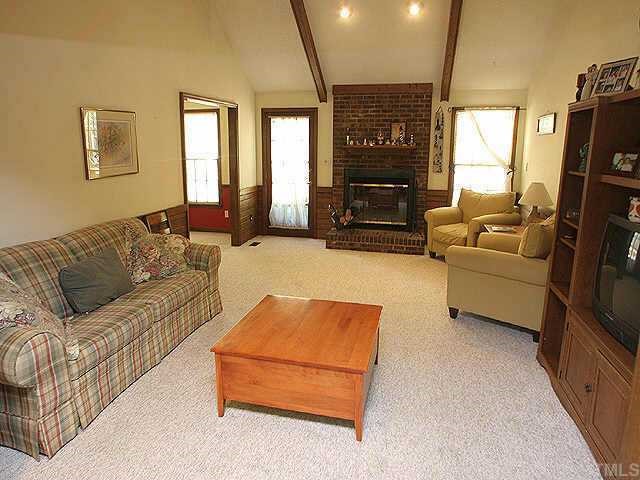 7437 Deer Track Drive Raleigh, NC 27613 - Photo 2 of 9 a living room with furniture and a flat screen tv