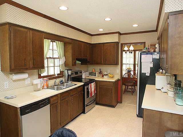 7437 Deer Track Drive Raleigh, NC 27613 - Photo 4 of 9 a kitchen with a sink stove and cabinets