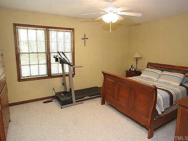 7437 Deer Track Drive Raleigh, NC 27613 - Photo 6 of 9 a bedroom with a bed and window