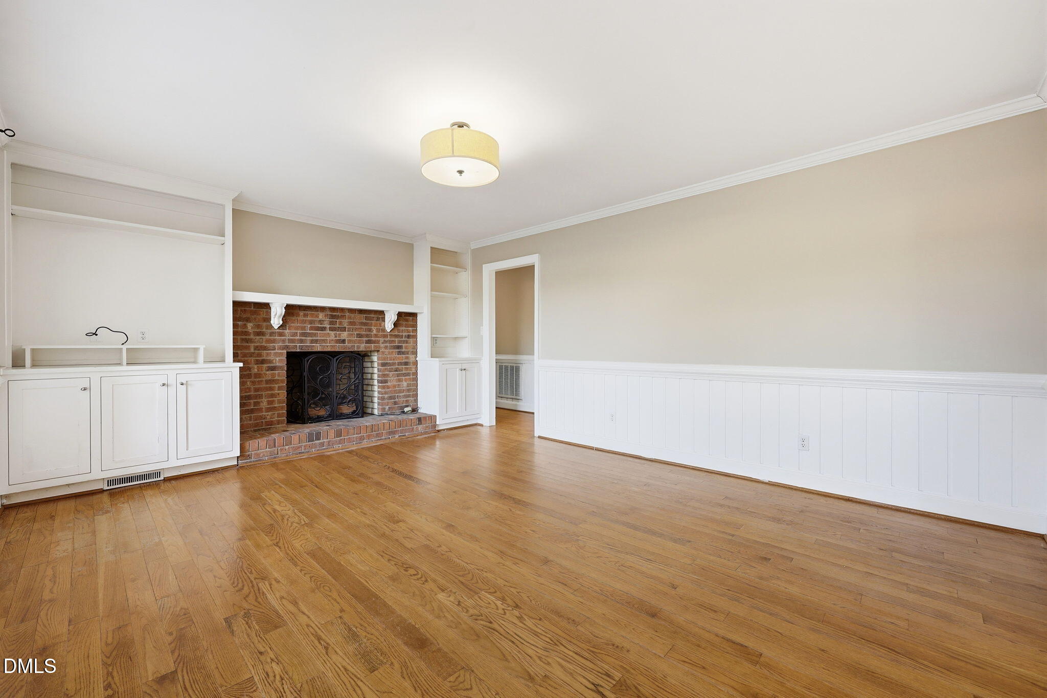 1130 Prospect Church Road Dunn, NC 28334 - Photo 20 of 47 an empty room with wooden floor and fireplace