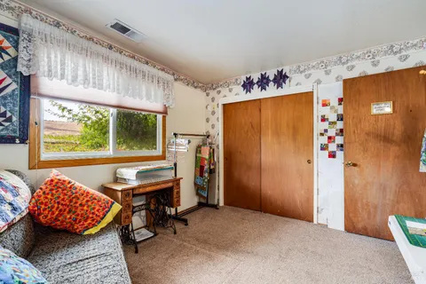 a bedroom with furniture and a window