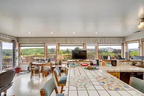 a living room with patio furniture and a flat screen tv
