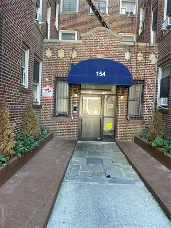a view of a house with a small yard and plants