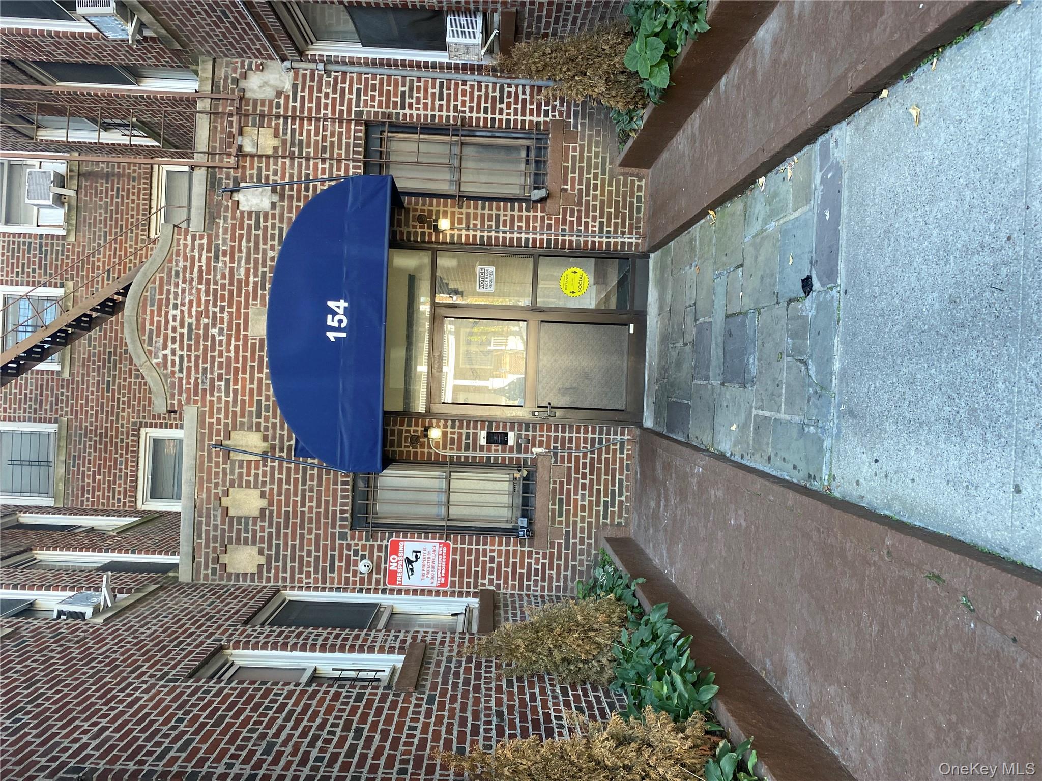a view of a house with a small yard and plants