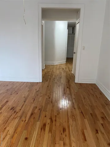 an empty room with wooden floor