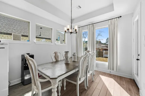 a dining room with furniture and window
